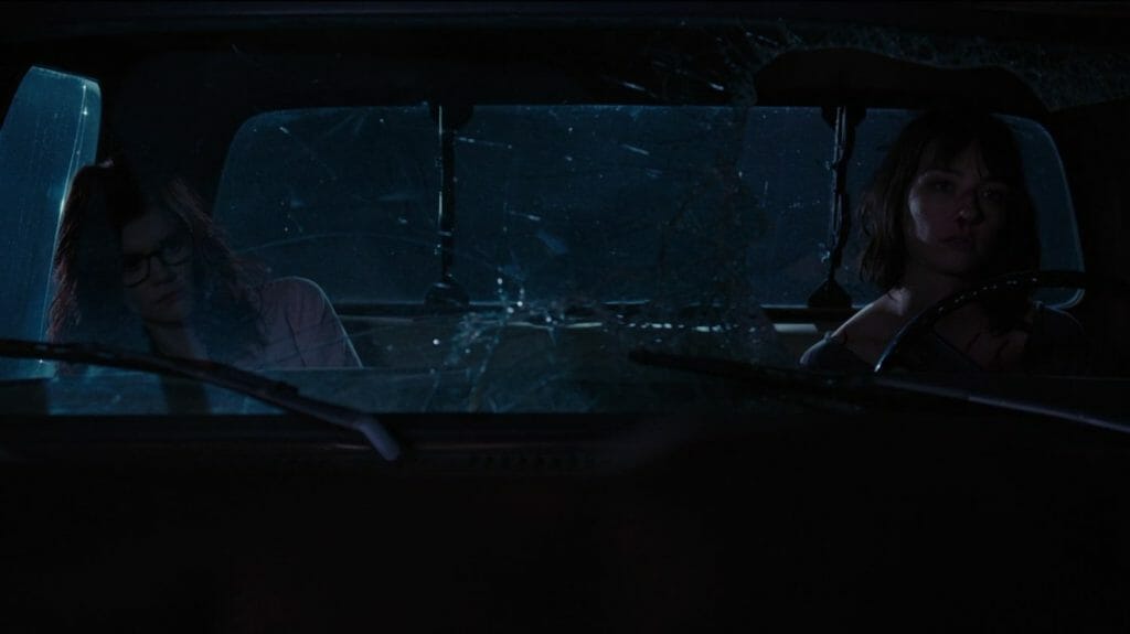 Screenshot of Zoe and Mary in a battered truck