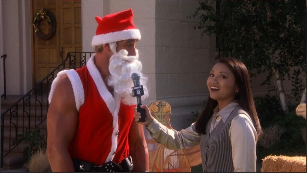 Hulk Hogan's character dressed as Santa Claus talking to a reporter