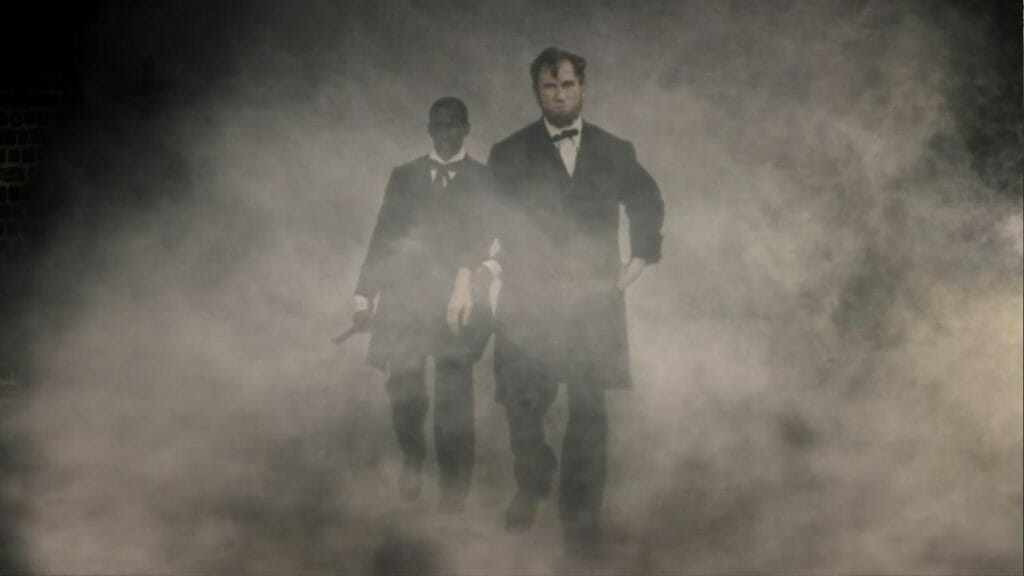 Picture of actor playing Abraham Lincoln, and an extra, walking through CGI smoke.